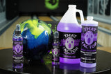 Various size bottles of That Wow Factor Ball Cleaner on a table in a bowling alley