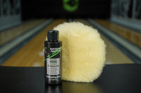 4oz TruCut Hand Applied Polish Plus and a CtD Premium Polishing Pad on a table in a bowling alley